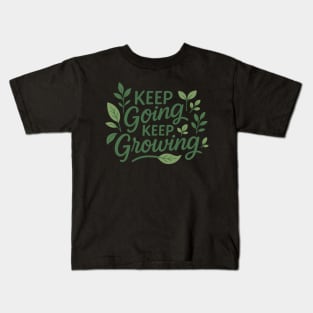 Modern lettering of "Keep Going, Keep Growing" with plant and leaf illustrations sprouting from the text, green and neutral tones Kids T-Shirt